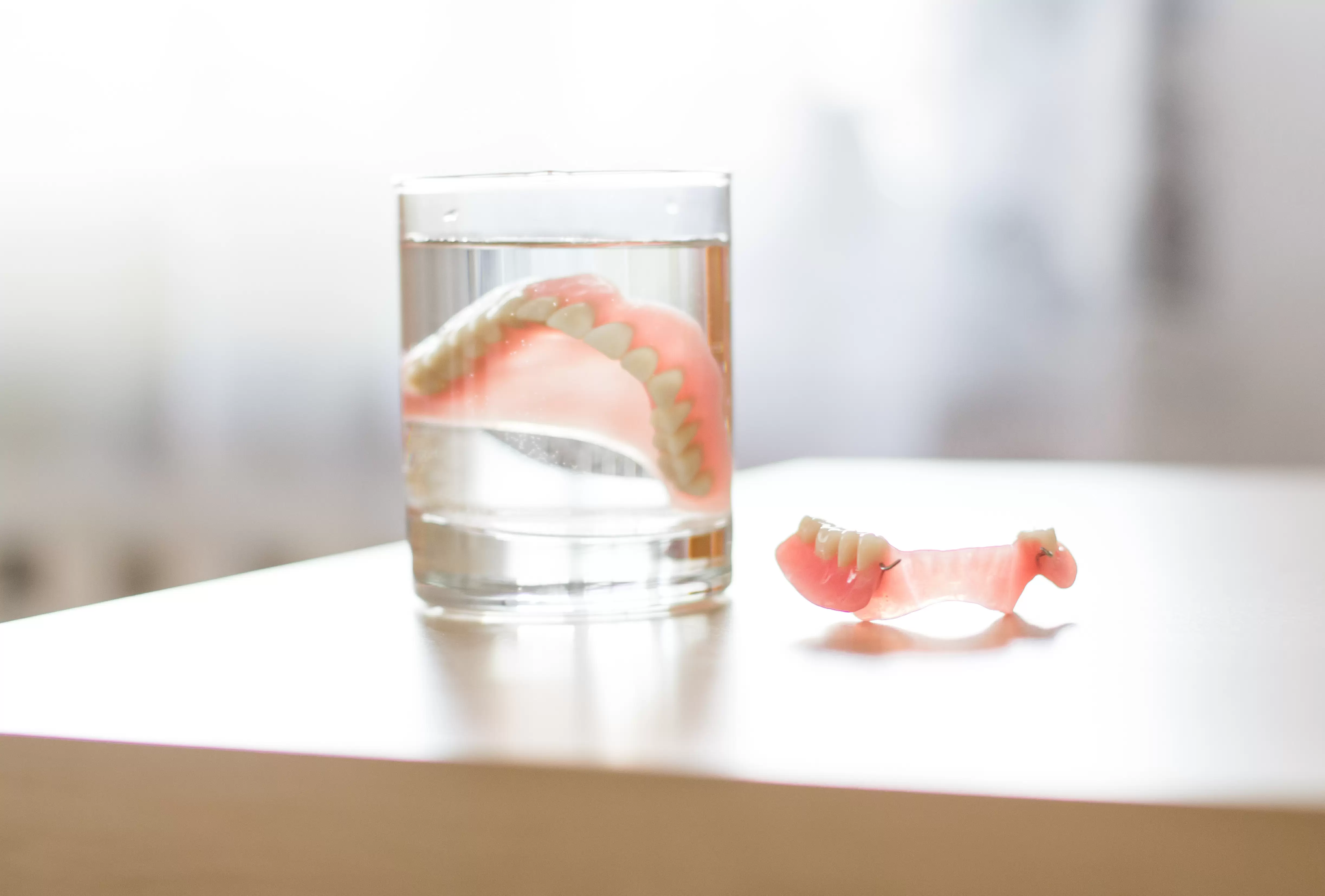 Traditionals dentures in Anchorage soaking in glass