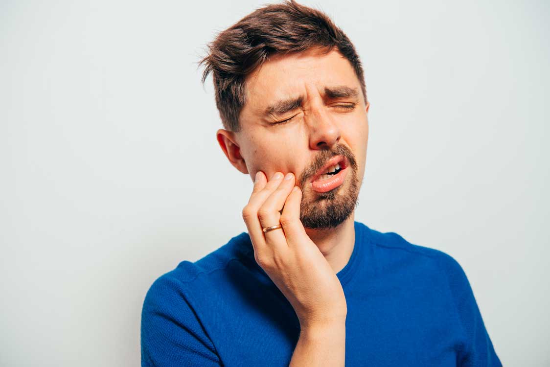 Man suffering from jaw pain in need of TMJ/tmd therapy